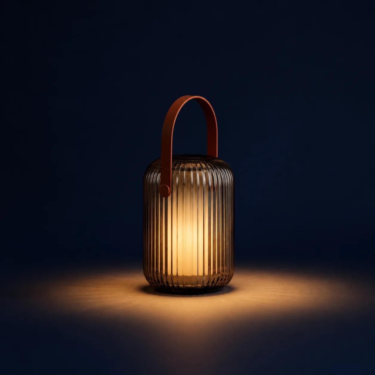 Glowing ribbed glass lamp with an orange handle